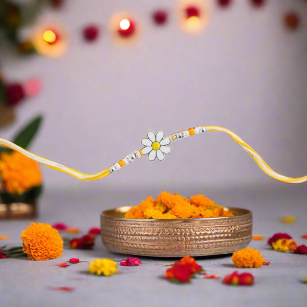 yellow rakhi featuring a delicate floral design