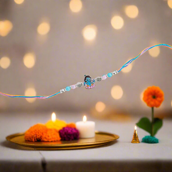 blue rakhi featuring a delicate Krishna motif.