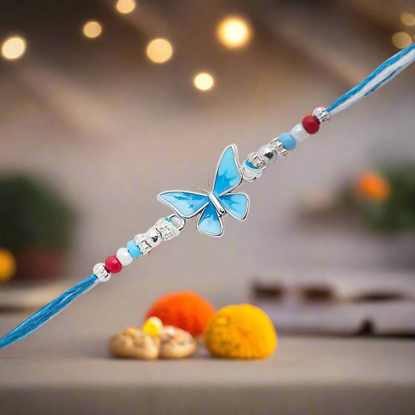 blue rakhi featuring a delicate butterfly design